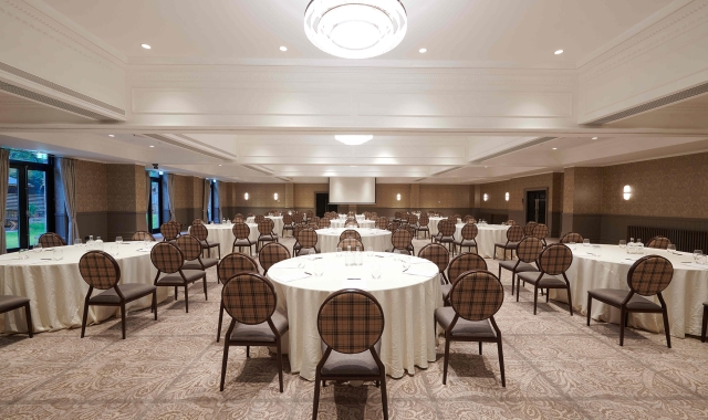 Large event space inside Cameron House with many tables and chairs for guests