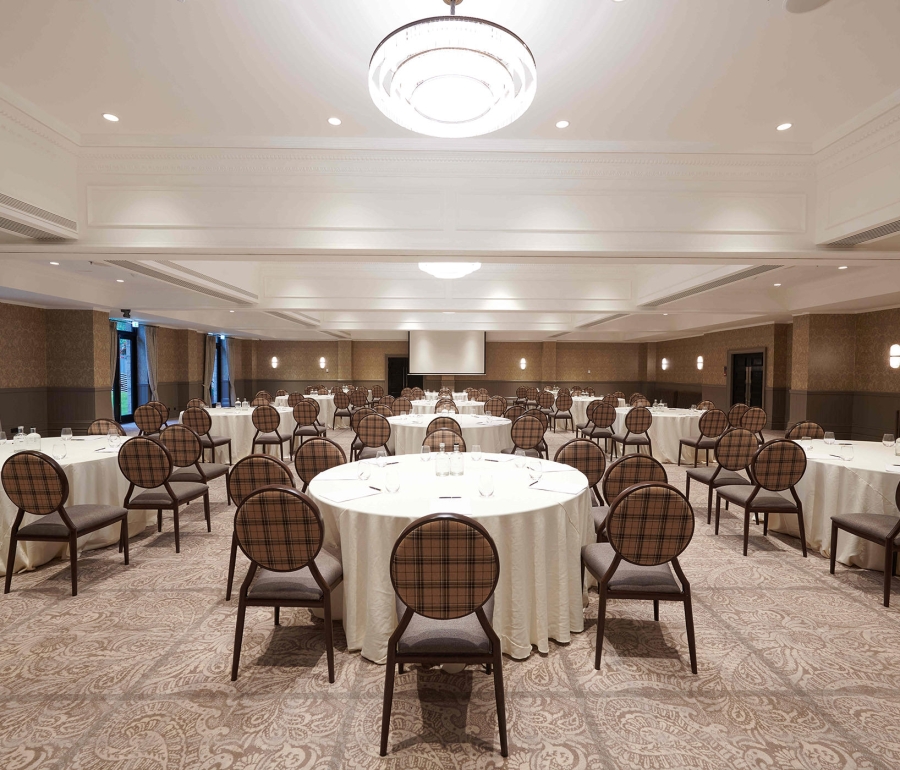 Large event space inside Cameron House with many tables and chairs for guests