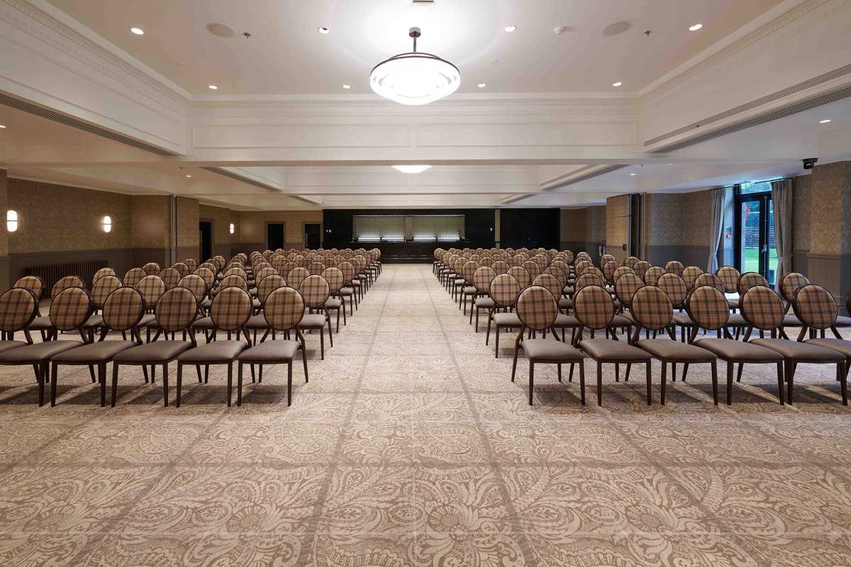 Event space located inside cameron house set up with many rows of seats and natural lighting