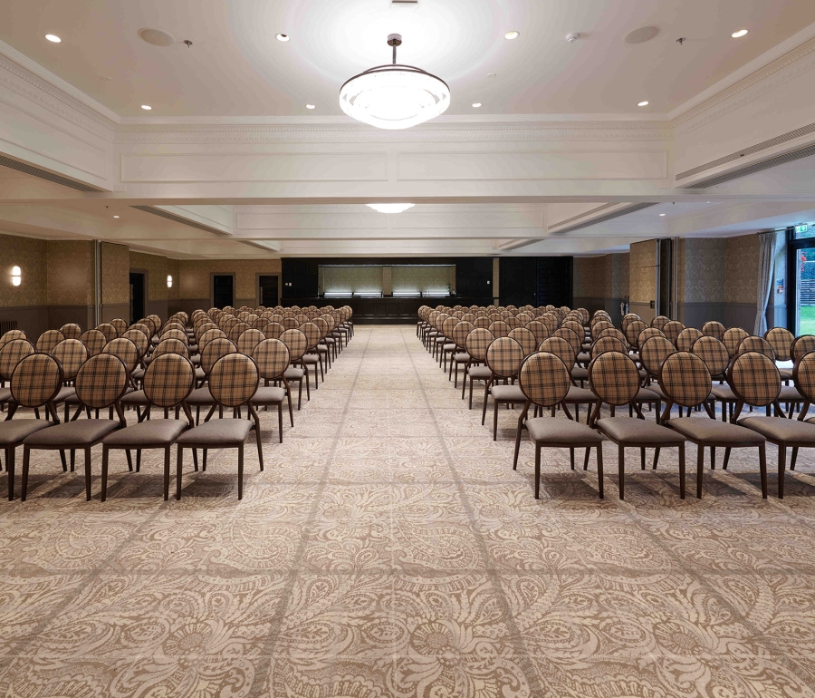 Event space located inside cameron house set up with many rows of seats and natural lighting