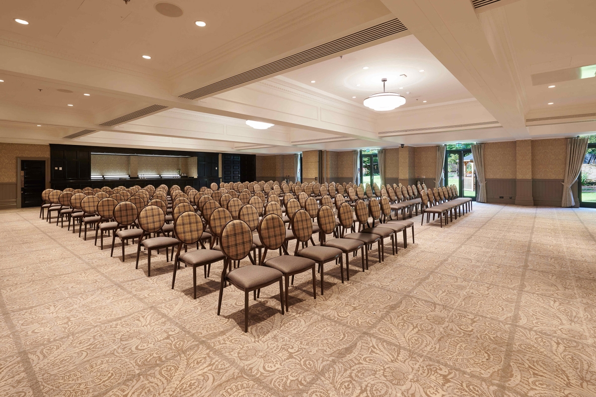 Rows of seating inside Cameron House event space with bright lighting