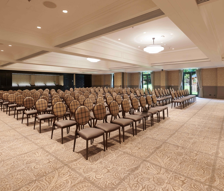 Rows of seating inside Cameron House event space with bright lighting