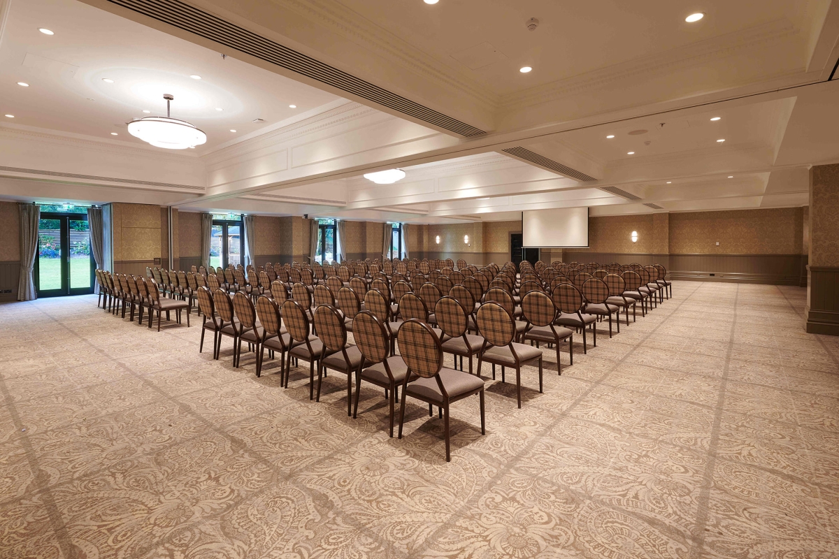 Rows of seating inside Cameron House event space large projector screen for presentations