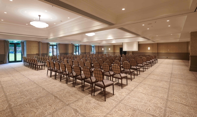 Rows of seating inside Cameron House event space large projector screen for presentations