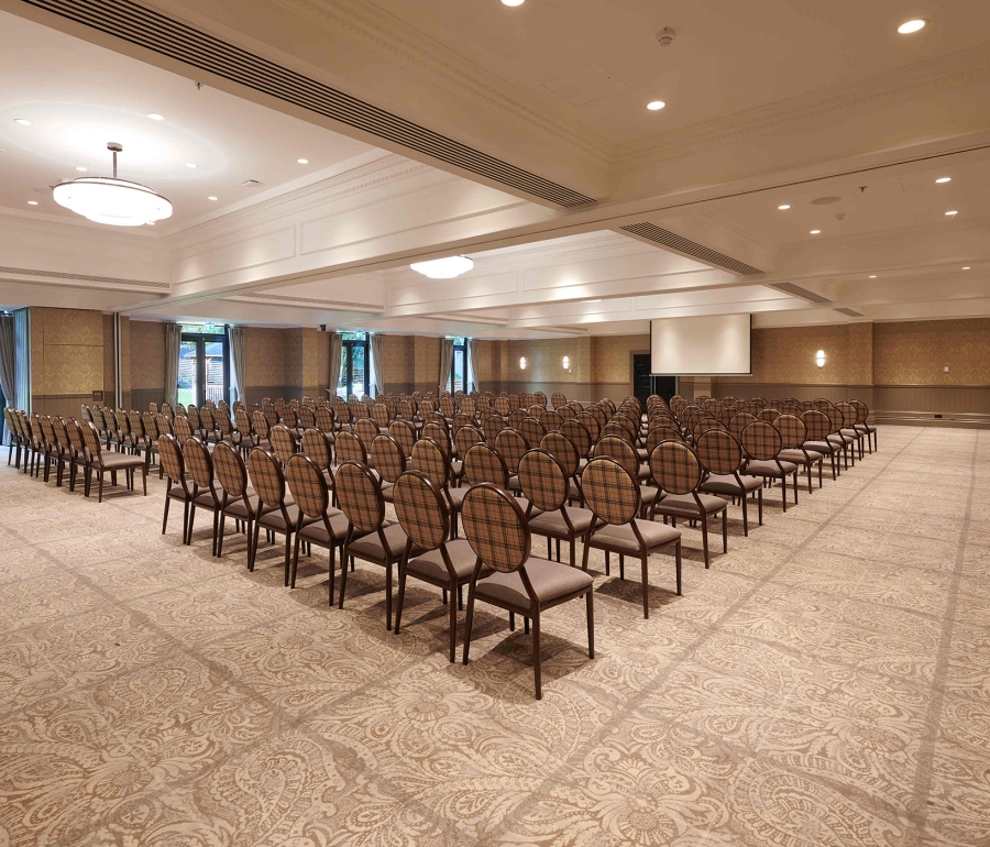 Rows of seating inside Cameron House event space large projector screen for presentations