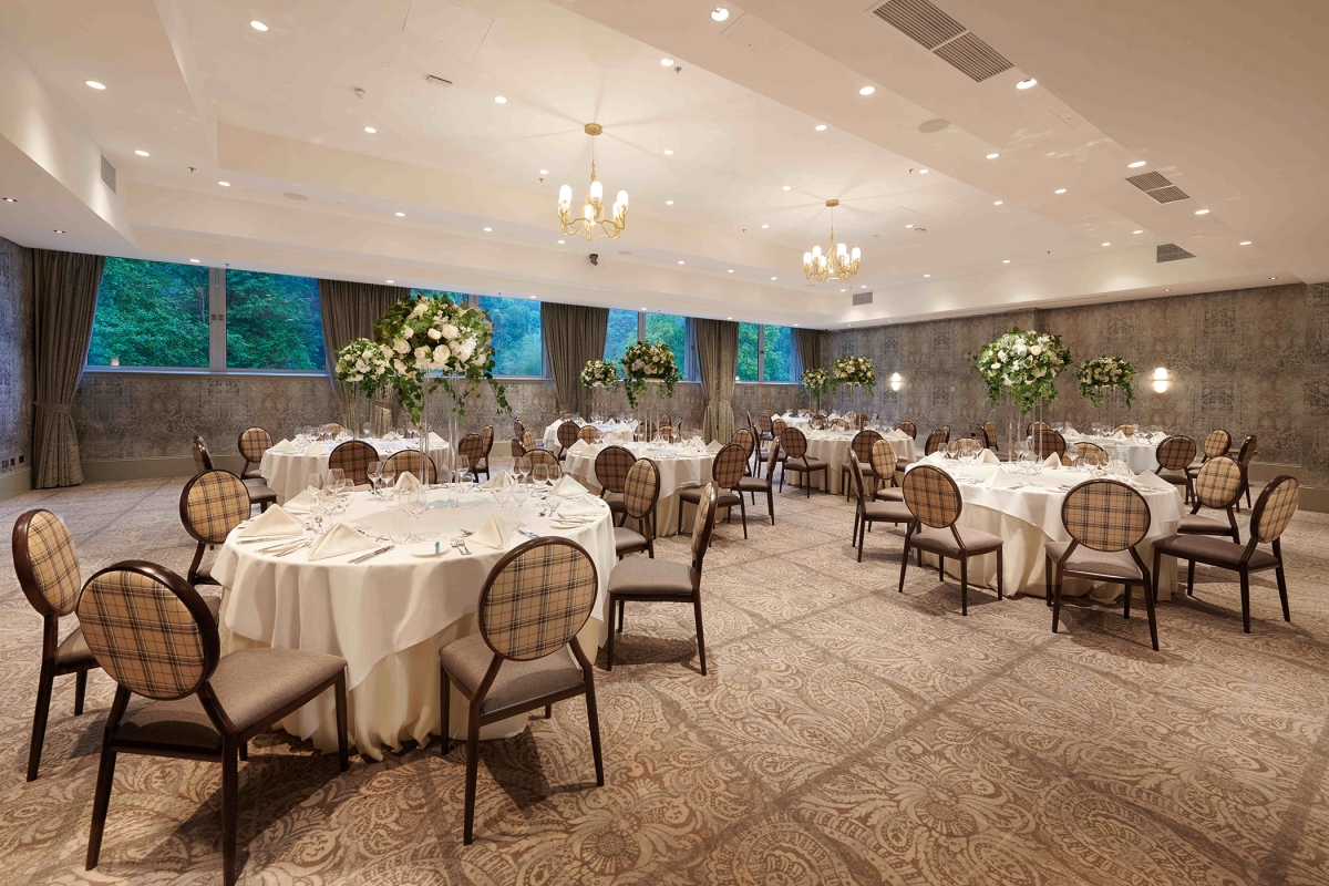 small table setup with floral bouquets in the center of the table and brown seats