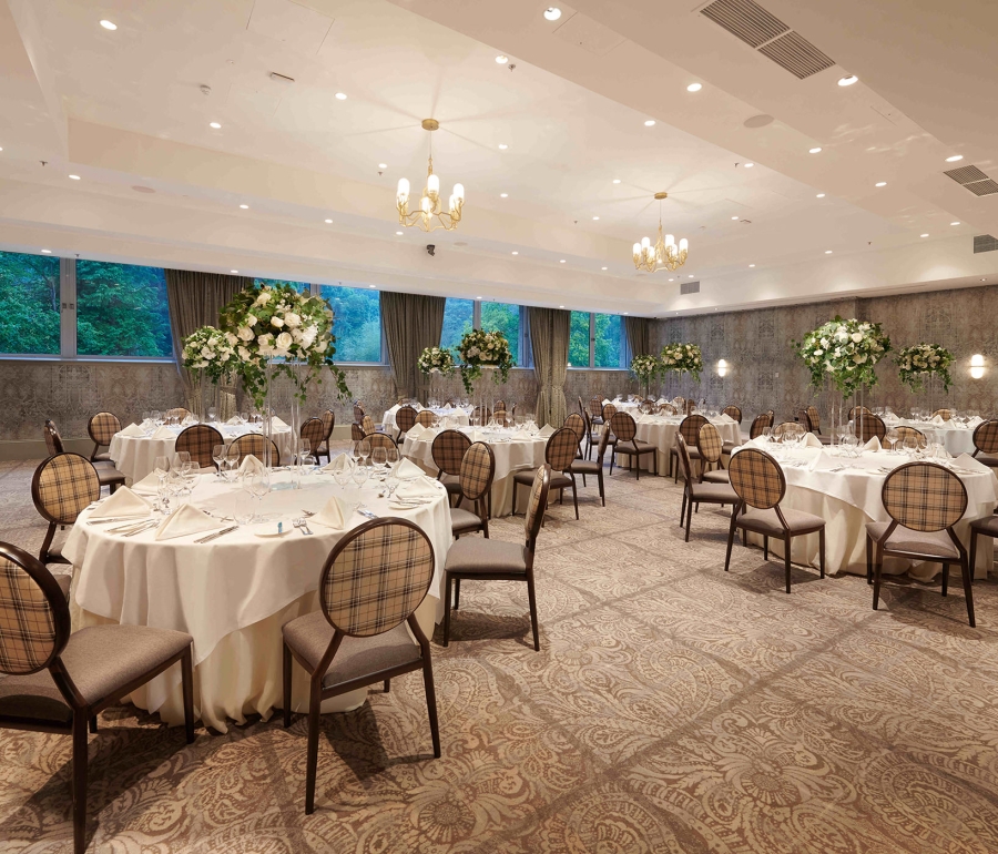 small table setup with floral bouquets in the center of the table and brown seats