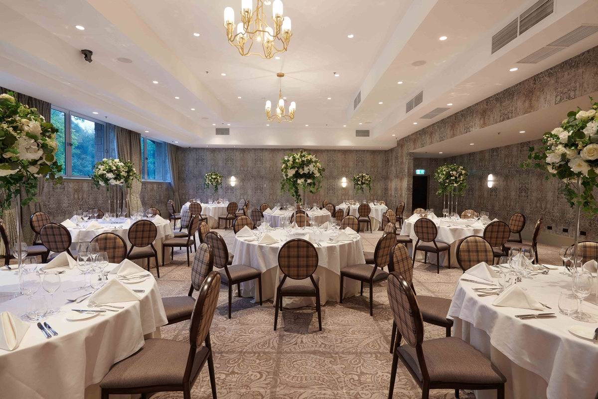 elegant chair and table arrangements inside a weeding space with side windows to look outside