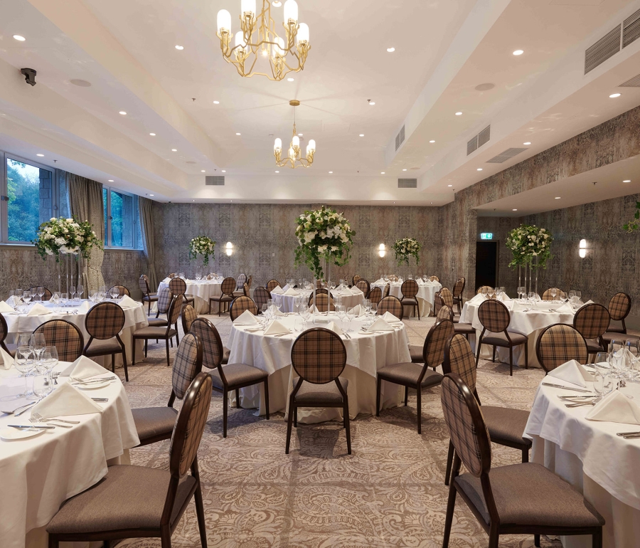 elegant chair and table arrangements inside a weeding space with side windows to look outside