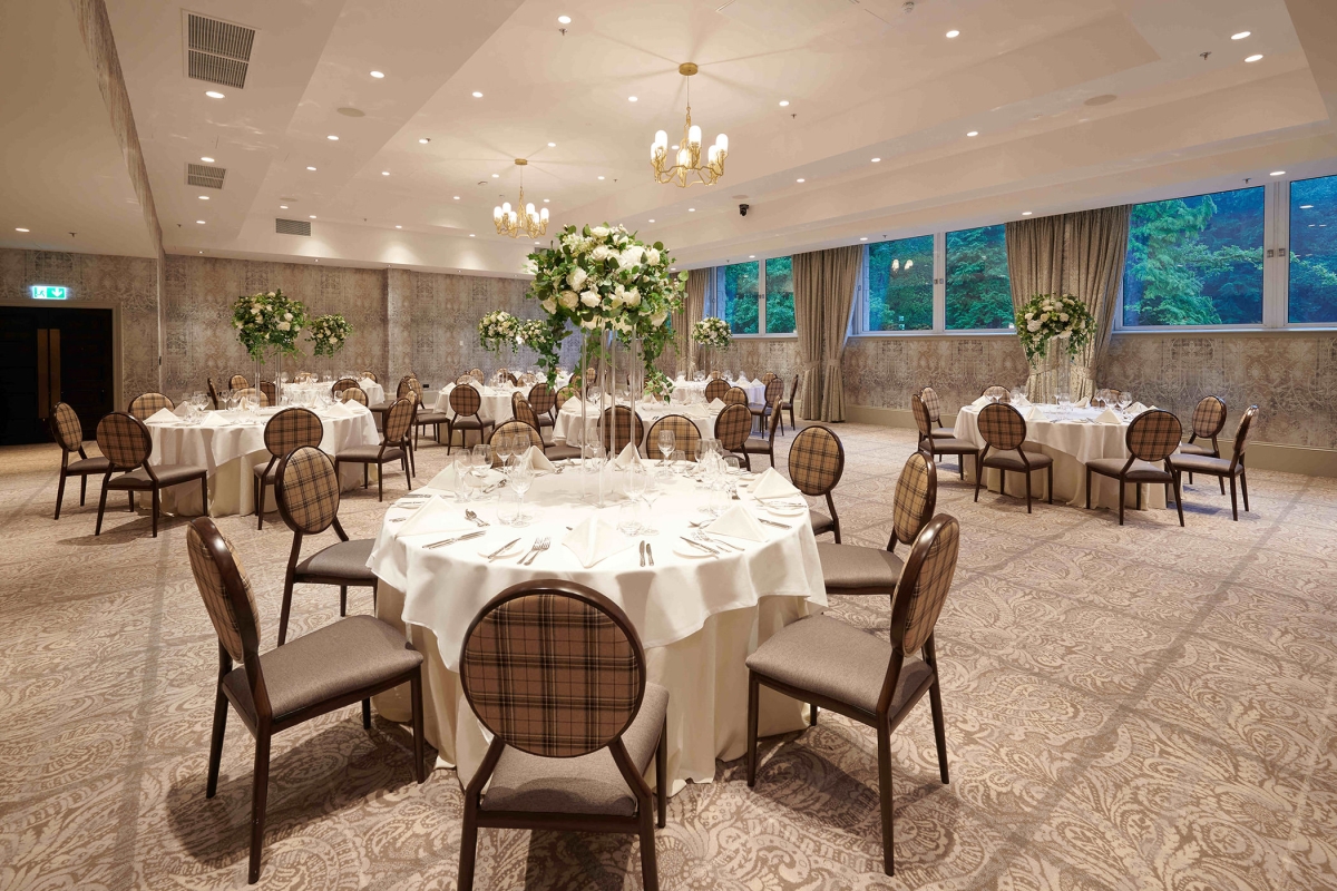 banquet setup with tables and chairs along with windows looking outside