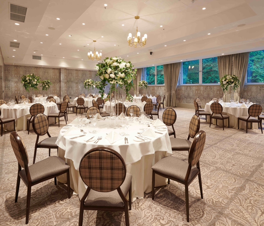 banquet setup with tables and chairs along with windows looking outside