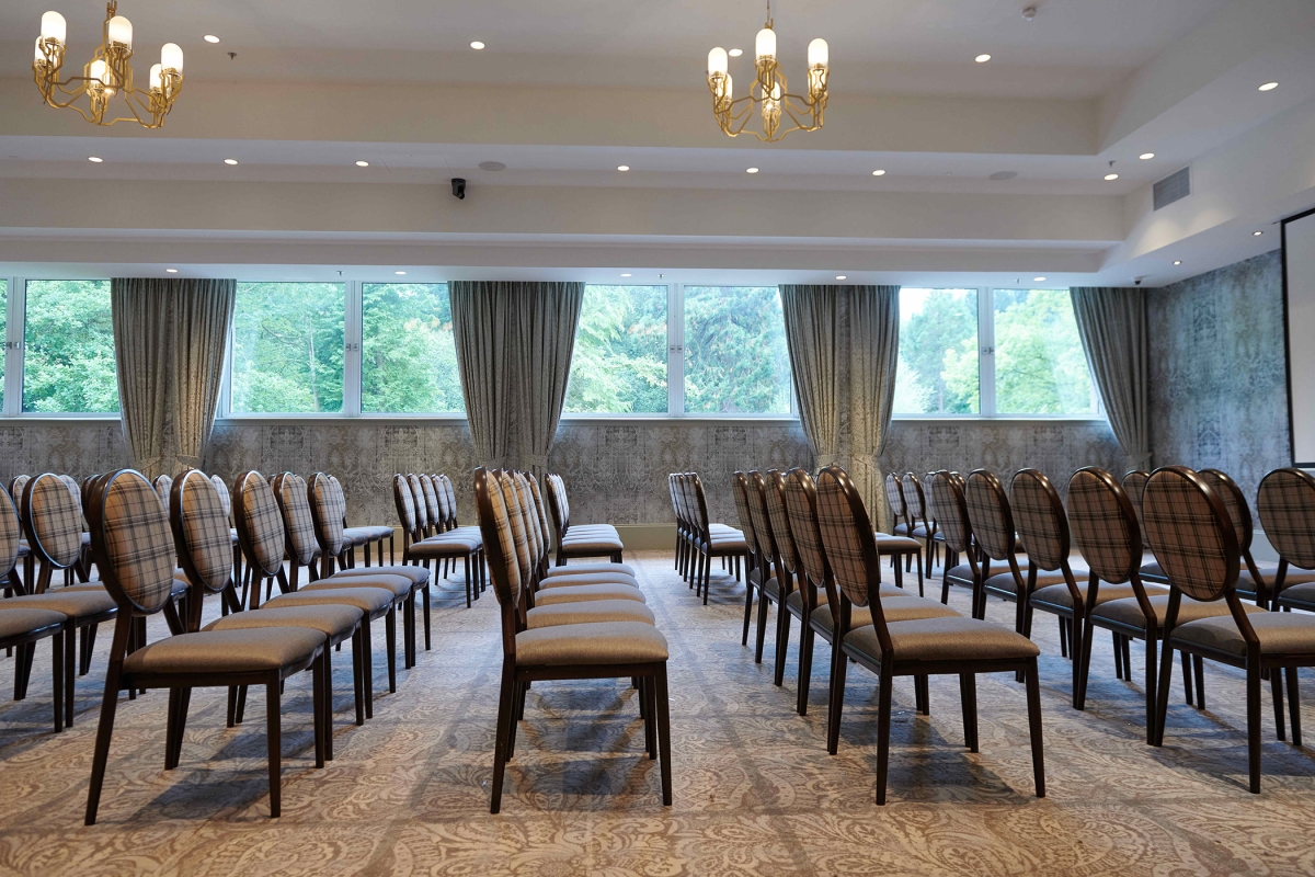 Side view of seating inside the event venue at Cameron House showing off the outside trees