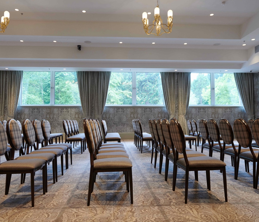 Side view of seating inside the event venue at Cameron House showing off the outside trees