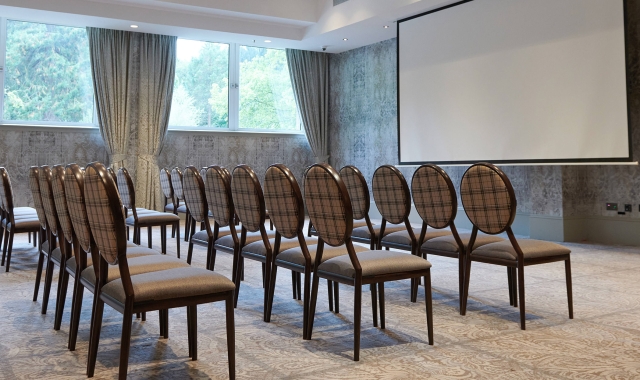 Front row seating with large projector screen inside the meeting venue at Cameron House