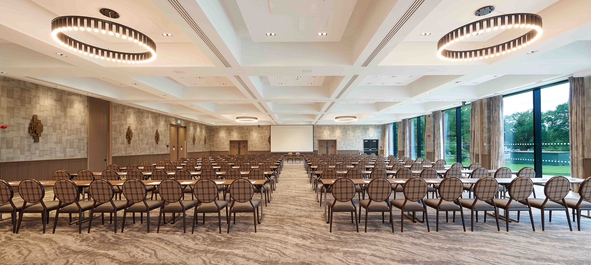 Expansive meeting room with amazing lighting and full sized windows to view the outside trees