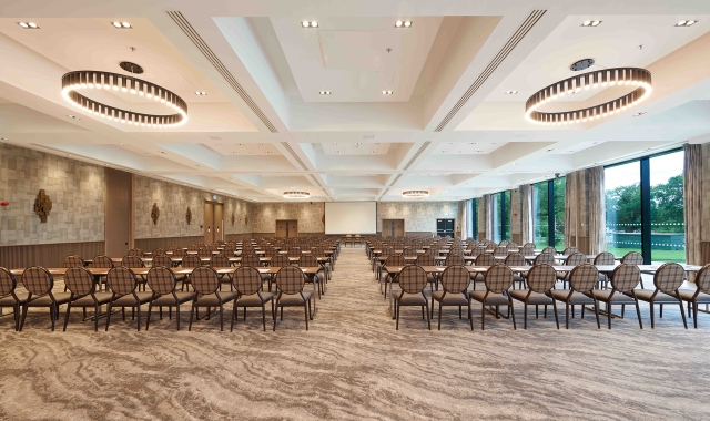 Expansive meeting room with amazing lighting and full sized windows to view the outside trees