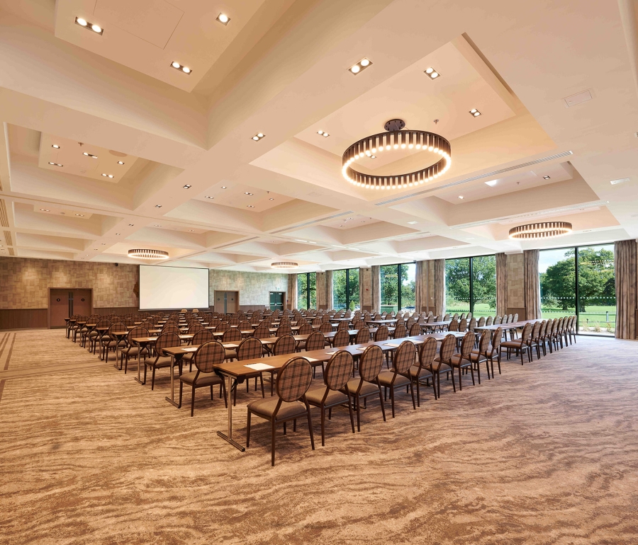 meeting room set up with rows of tables and chairs along with great outside views and lots of natural lighting