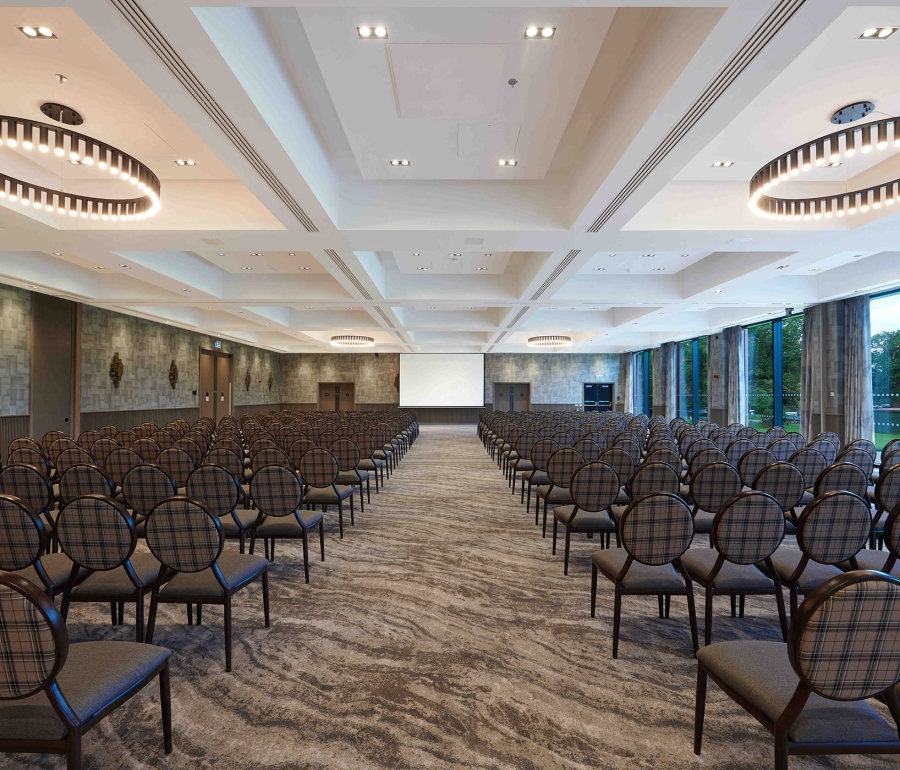 large walking space in between rows of chairs leading to a full sized projector