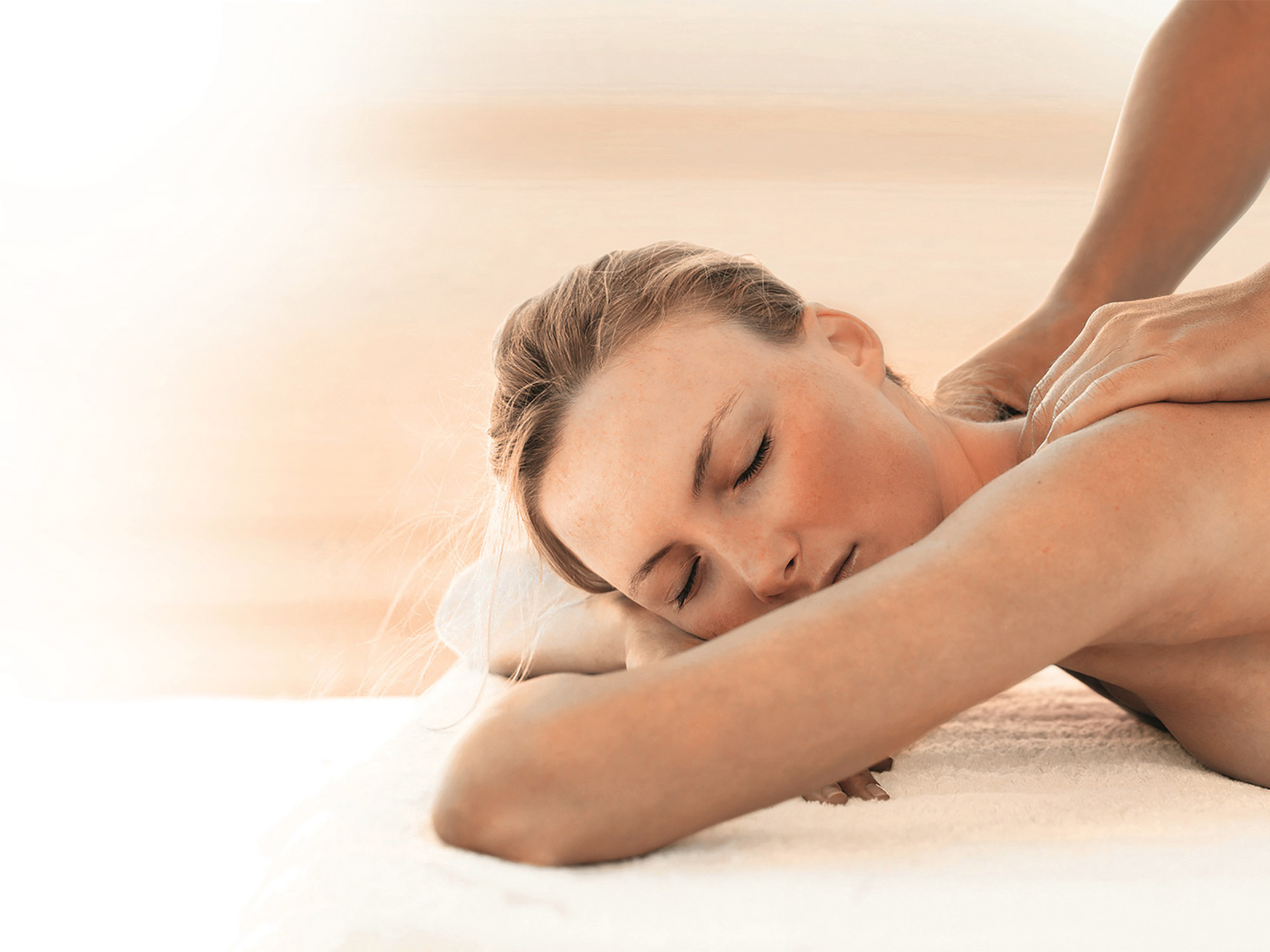 a woman getting her shoulders massaged in a spa