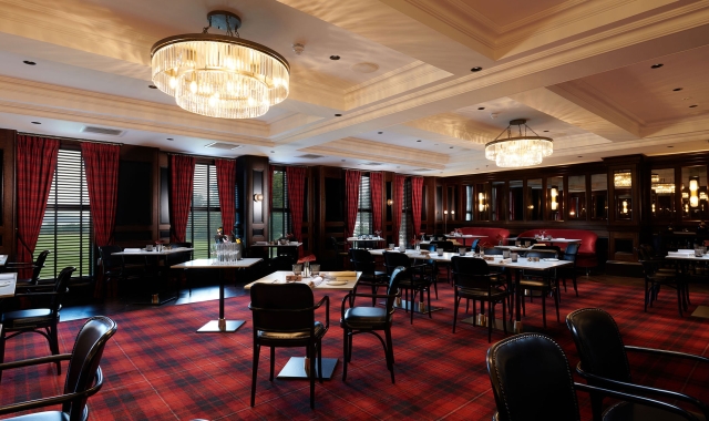 large dining room with black chairs and tables