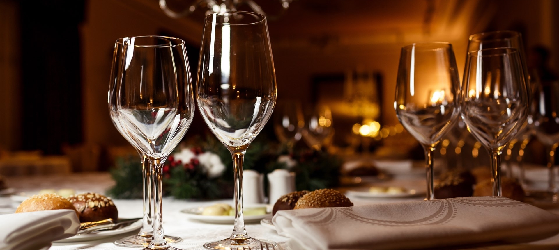 close up view of wine glasses on a table set up for dinner