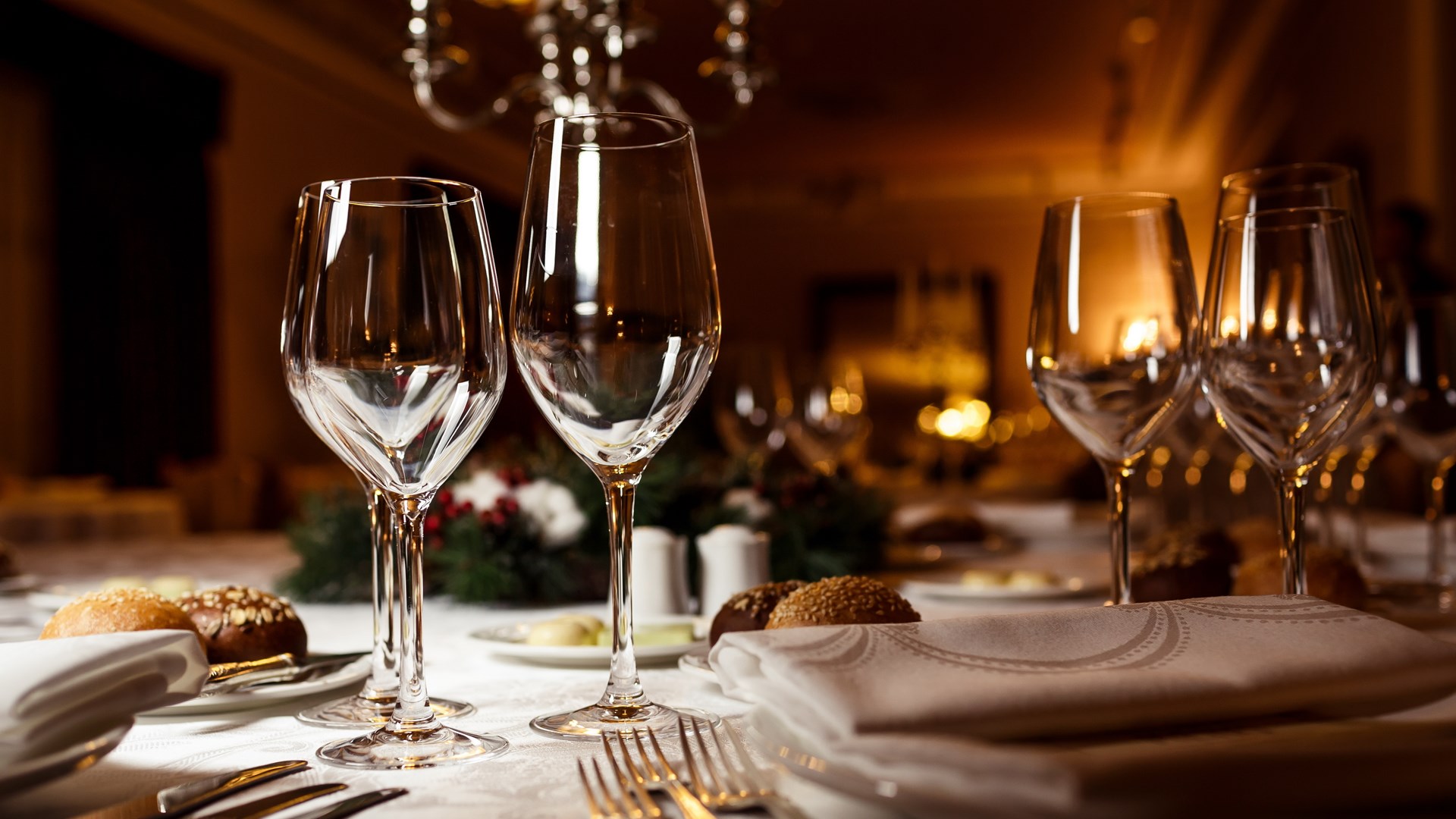 close up view of wine glasses on a table set up for dinner