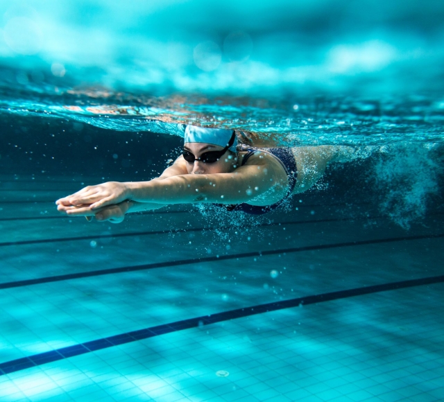 a woman diving in a swimming pool