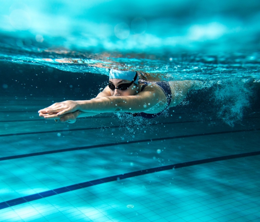 a woman diving in a swimming pool