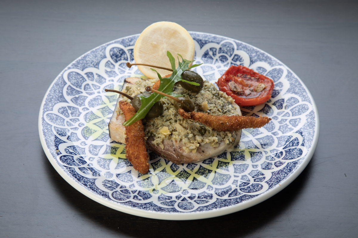 Swordfish dish with lemon on plate, served at La Vista restaurant.