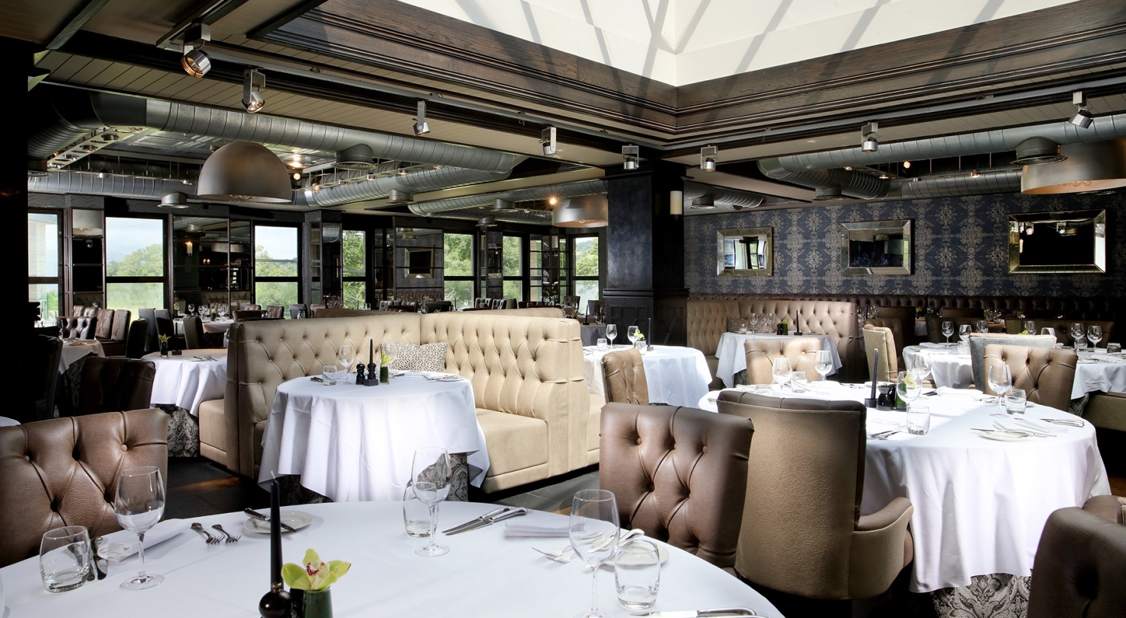 big dining room with white tables and brown chairs