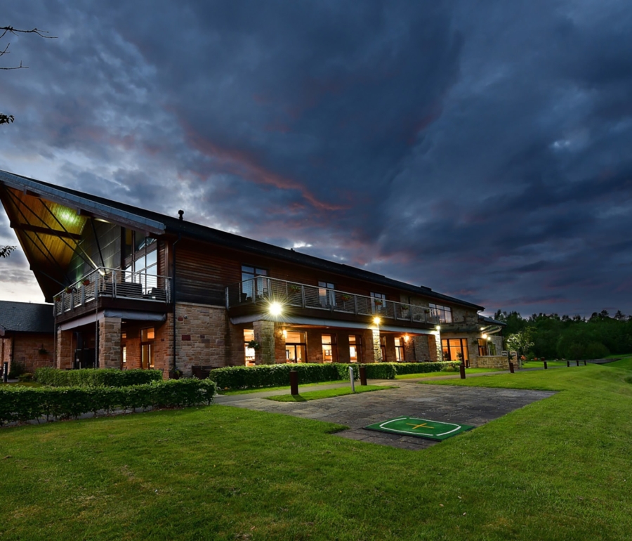 the exterior of a building on a dark stormy night