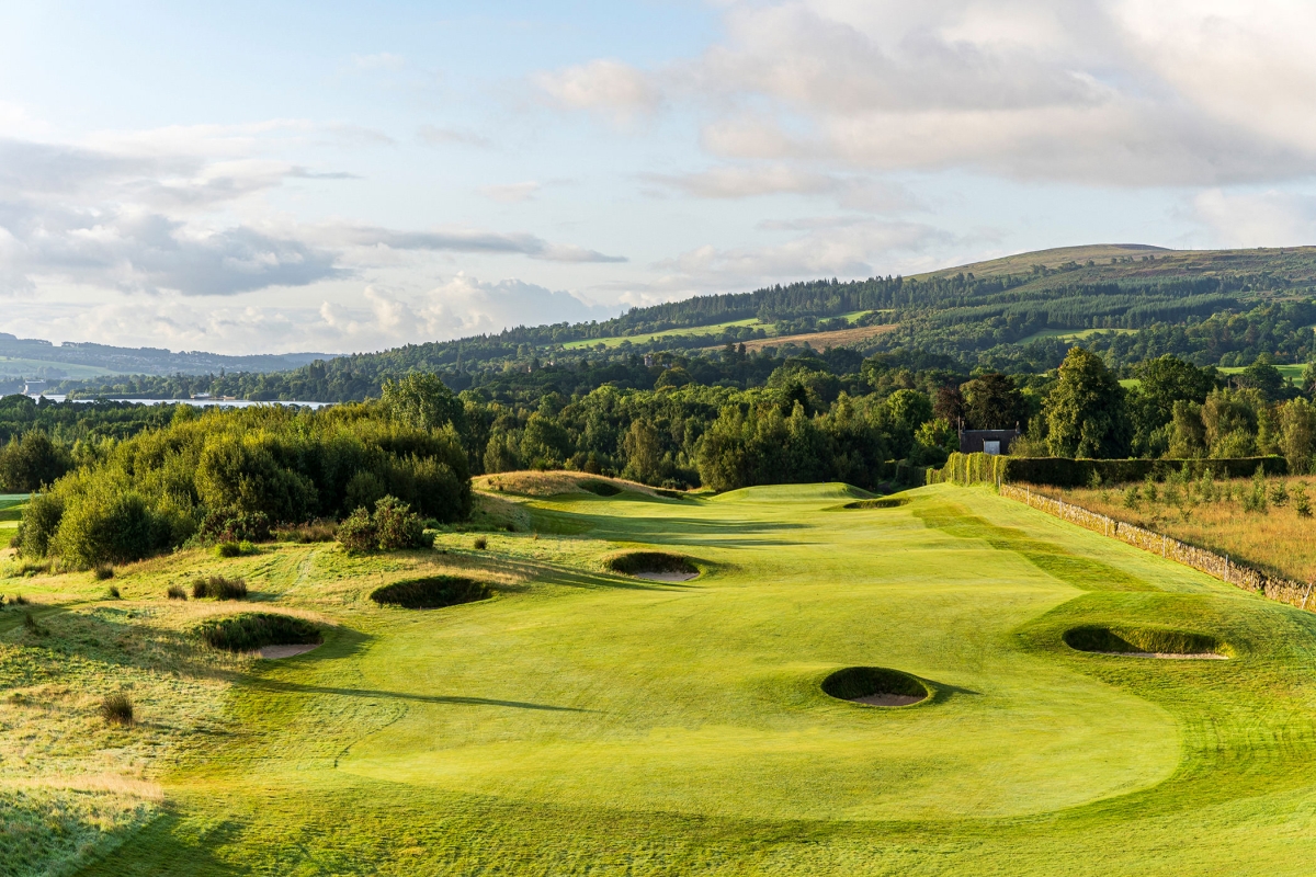 a golf course with multiple sand dunes and trees surrounding the course