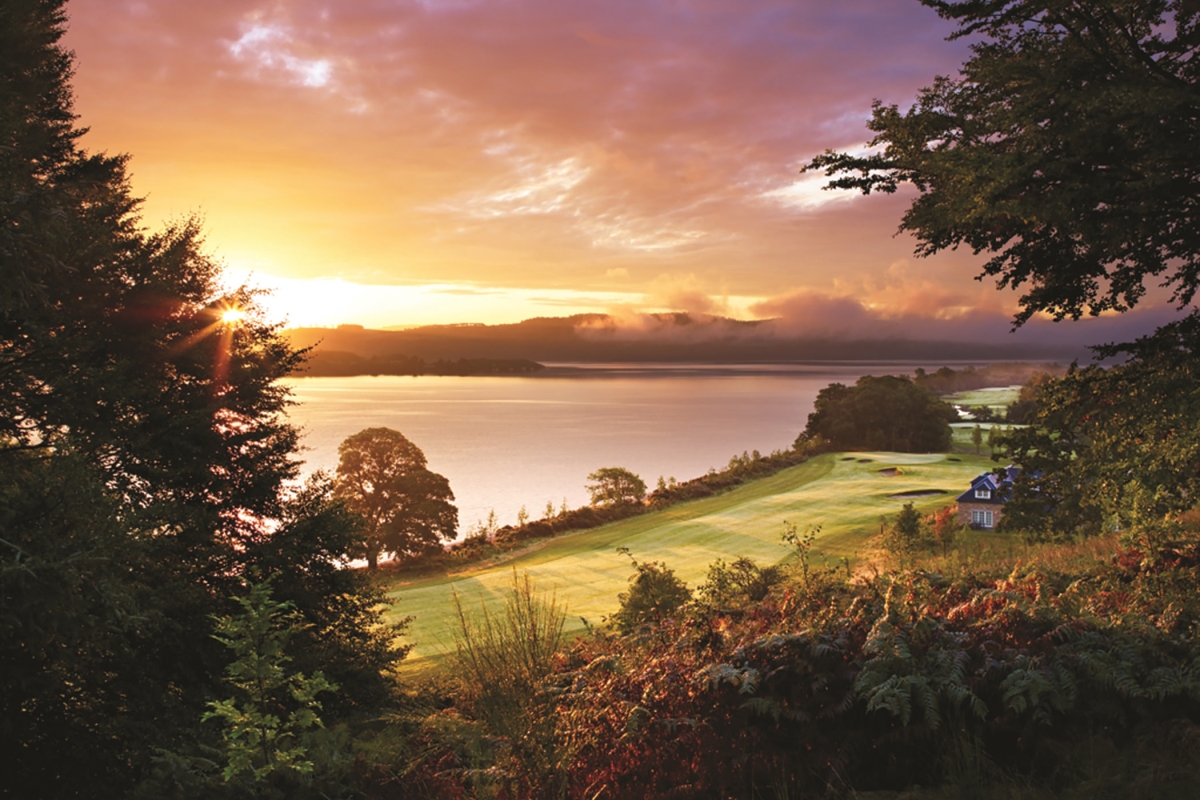 over head view of a golf course with the sun setting in the back ground