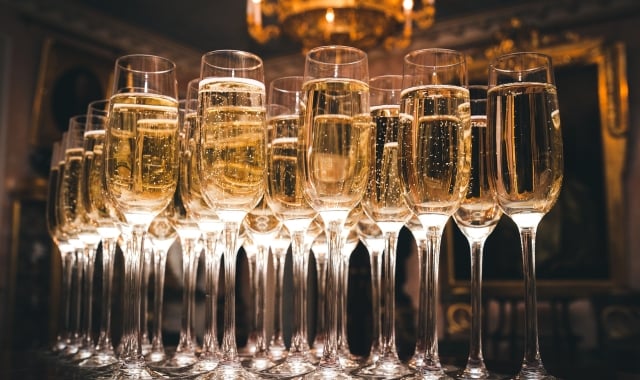 a row of glasses filled with champagne