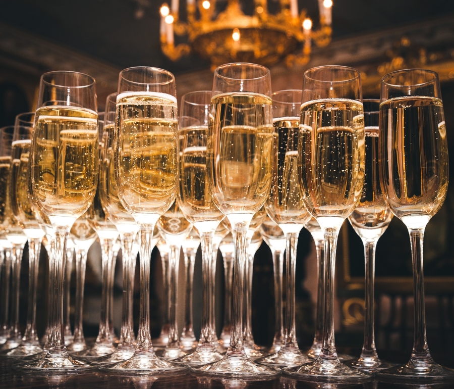 a row of glasses filled with champagne