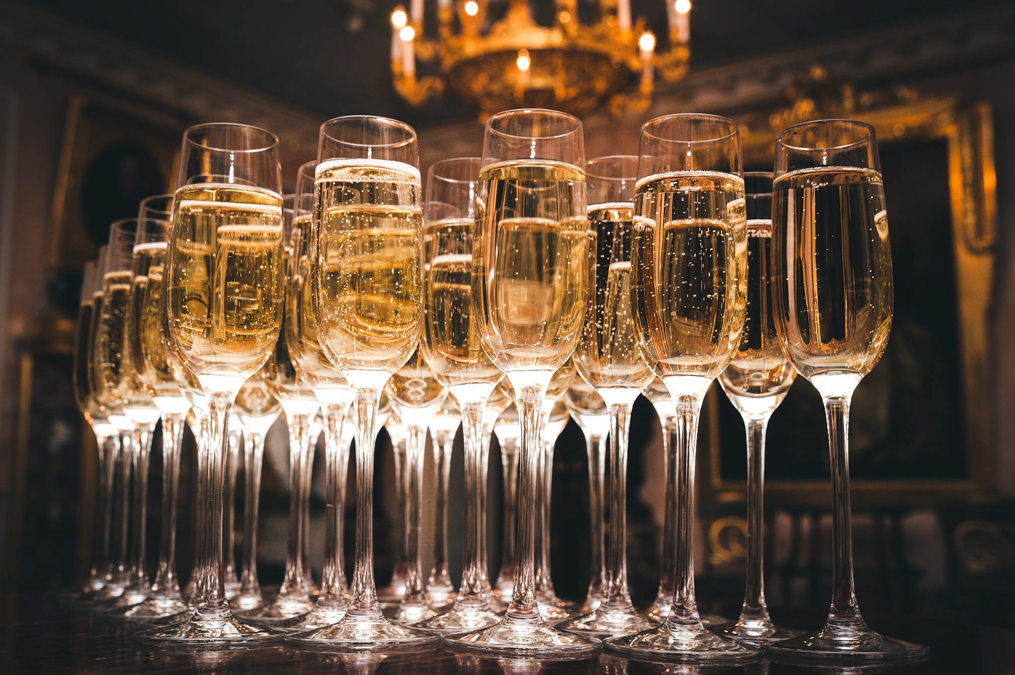 a row of glasses filled with champagne