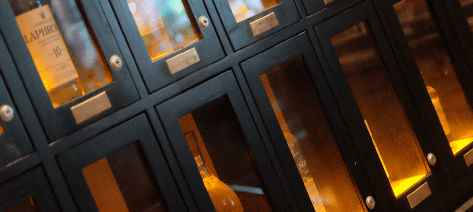 close up view of bottles of whiskey sitting inside a locked case