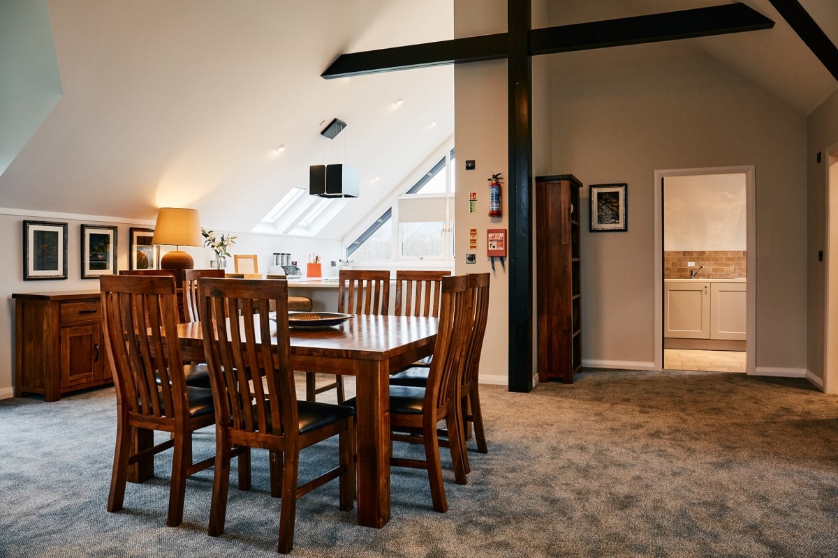Dining area with a wooden table and chairs in attic space
