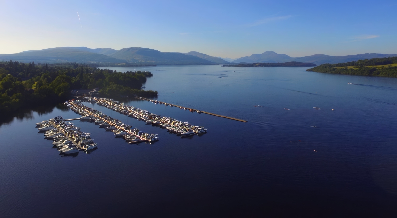 Marina boat slips filled with boats on Loch. Lomond at Cameron House.