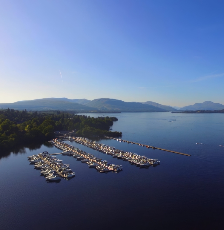 Marina boat slips filled with boats on Loch. Lomond at Cameron House.