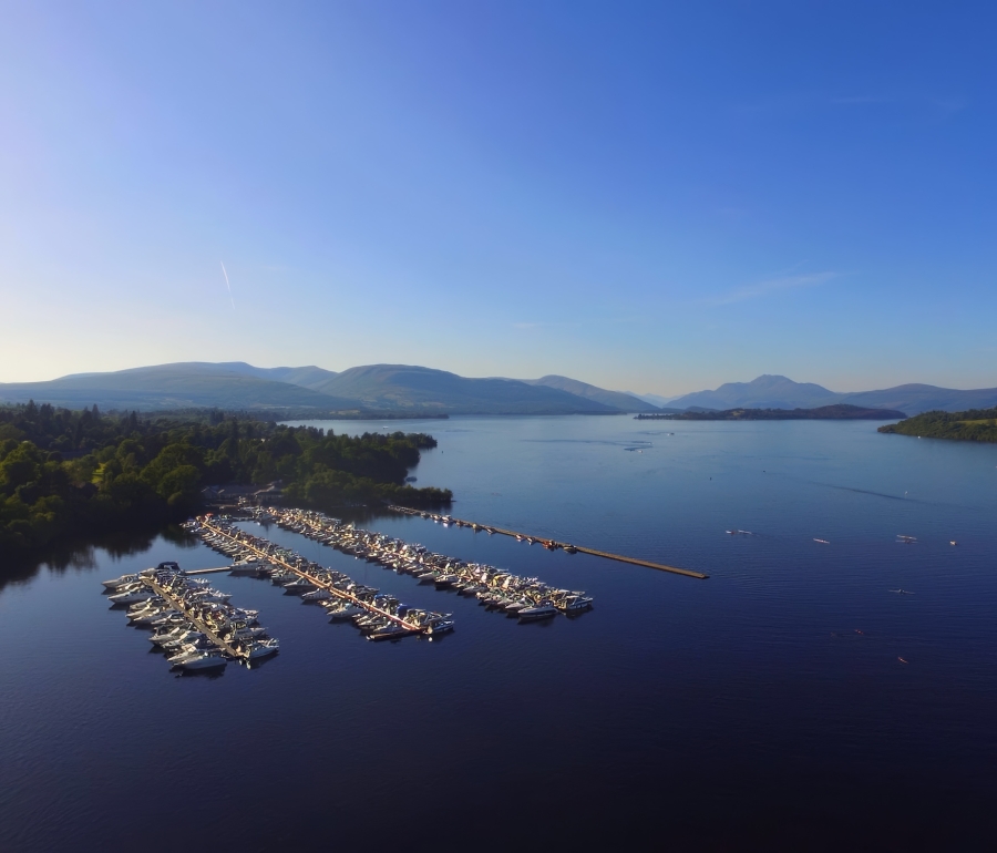 Marina boat slips filled with boats on Loch. Lomond at Cameron House.
