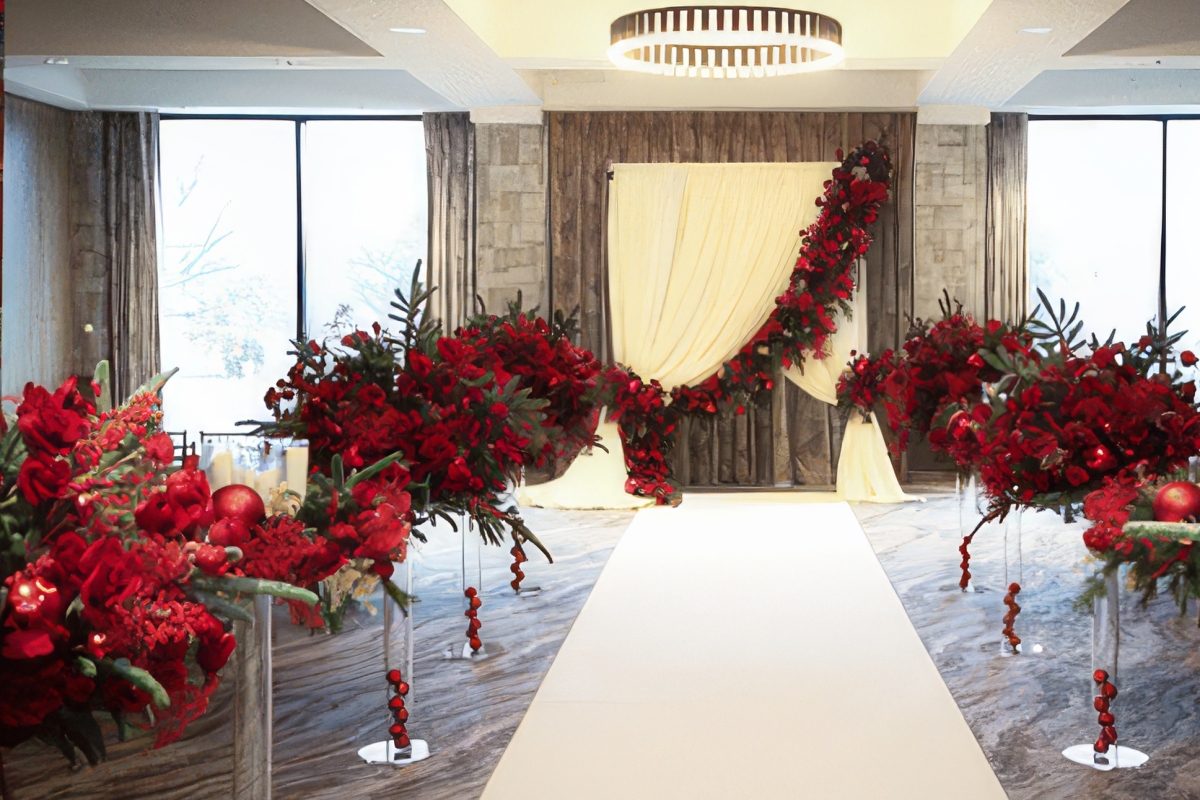 A wedding ceremony aisle adorned with red roses