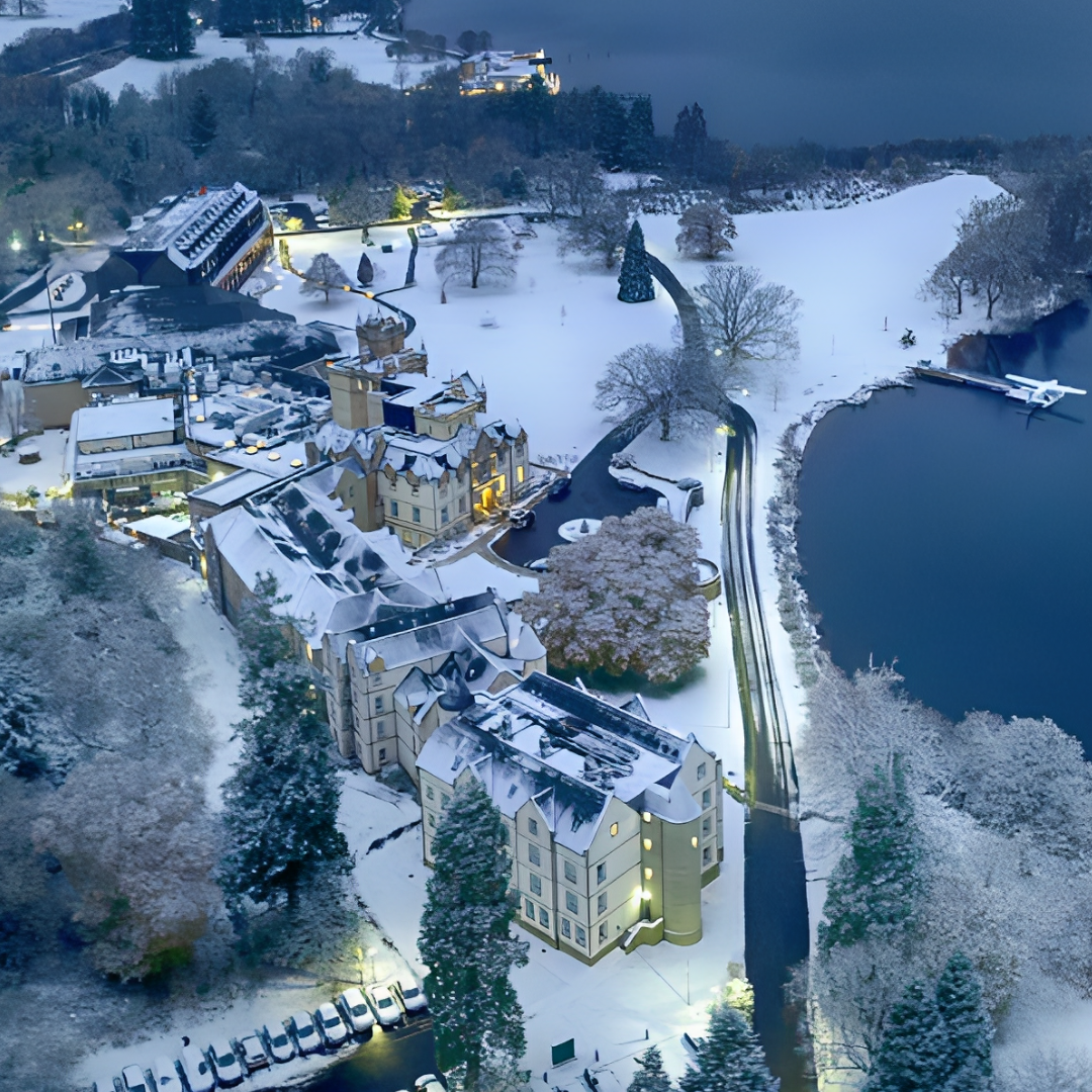 Cameron House Hotel and Resort covered in winter snow beside Loch Lomond - drone photograph