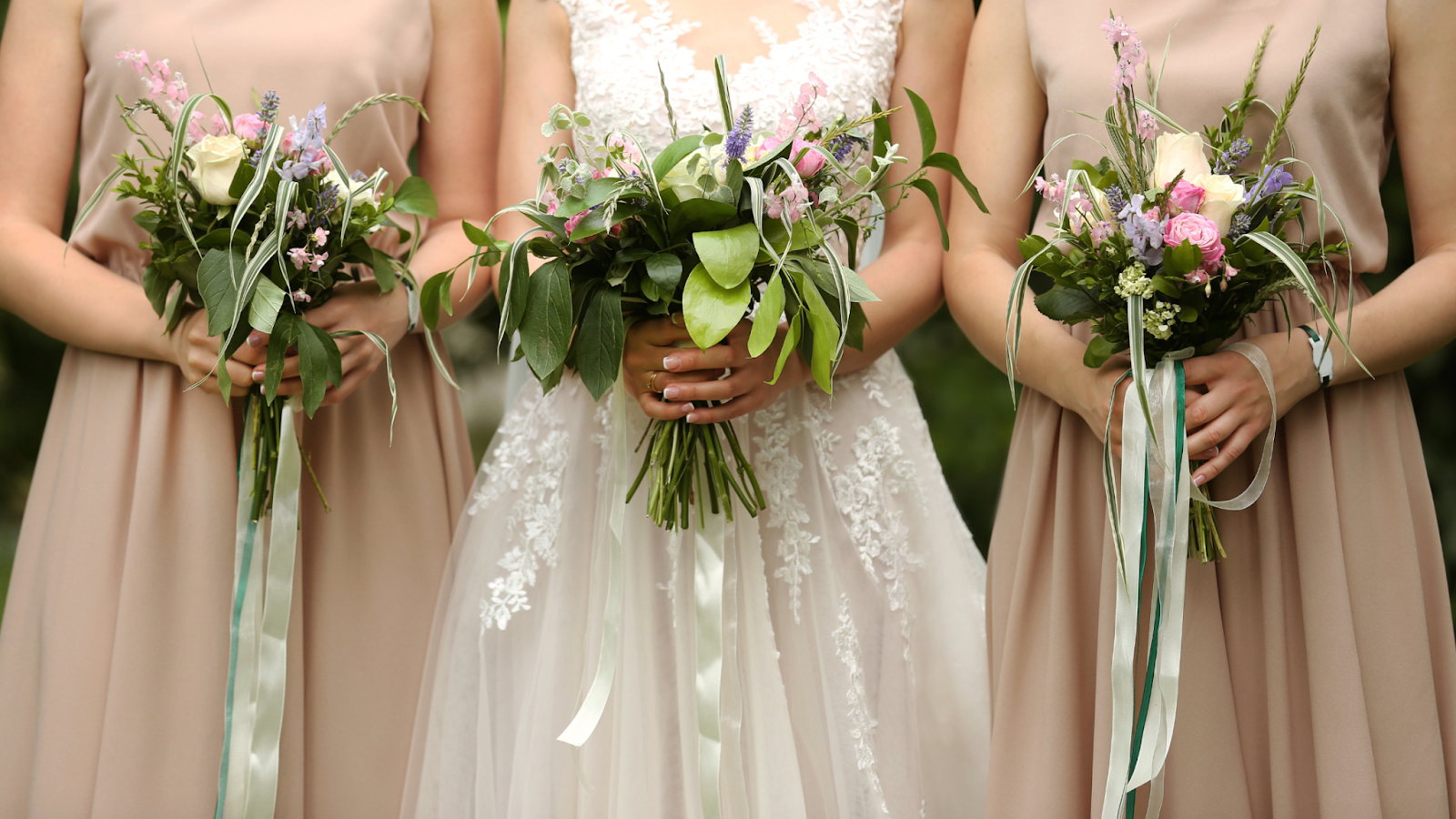 A bride and bridesmaids holding bouquets.