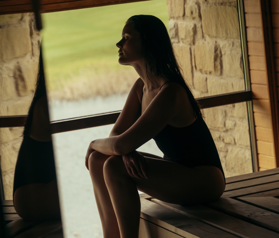 Woman reflecting in the sauna at The Spa at The Carrick