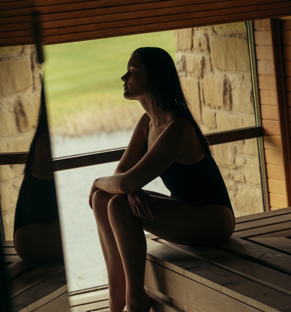 Woman reflecting in the sauna at The Spa at The Carrick