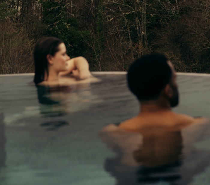 Couple in the rooftop pool at The Spa at The Carrick